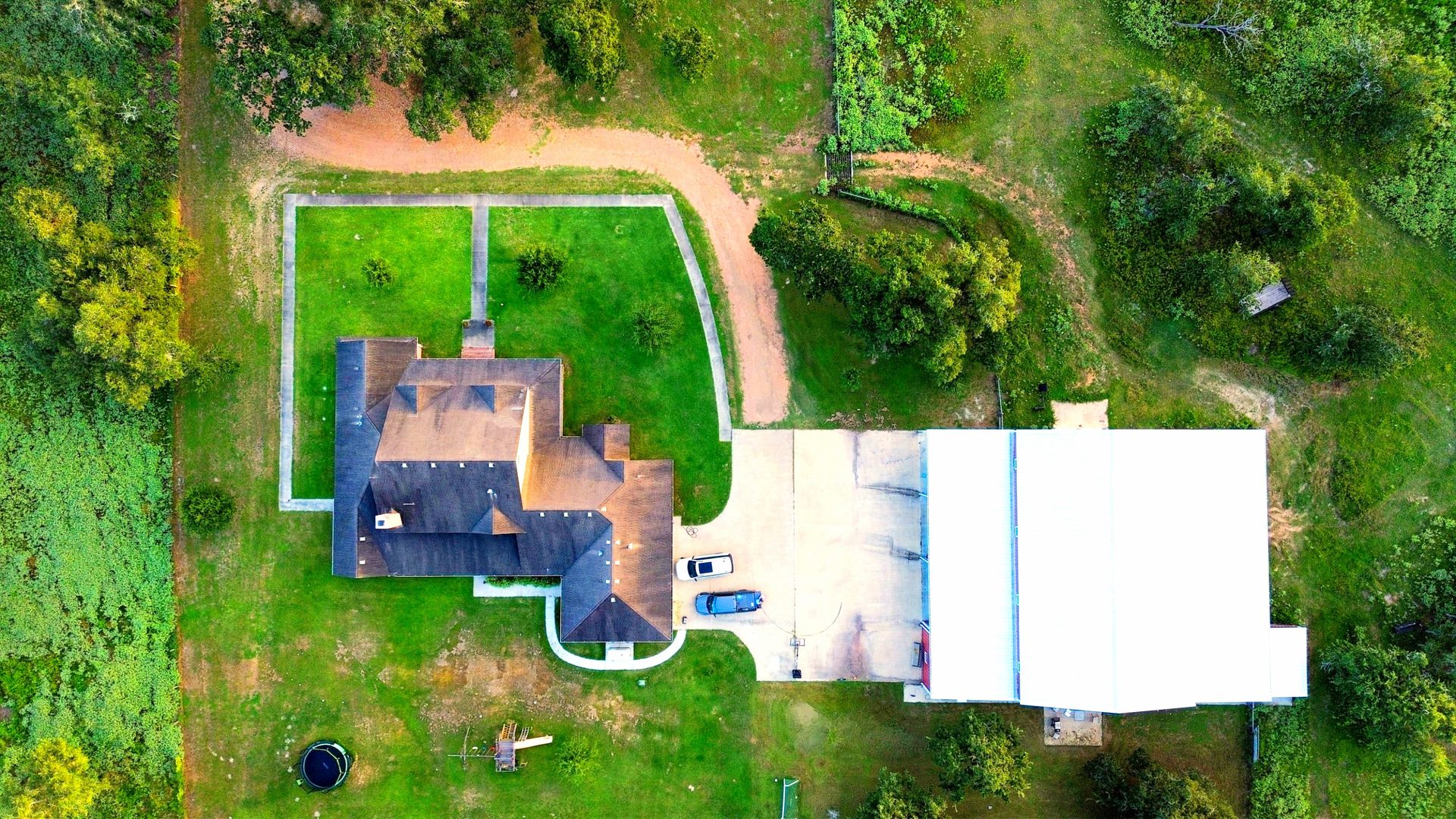 Top-down aerial showing the farmhouse, shop building, and full acreage