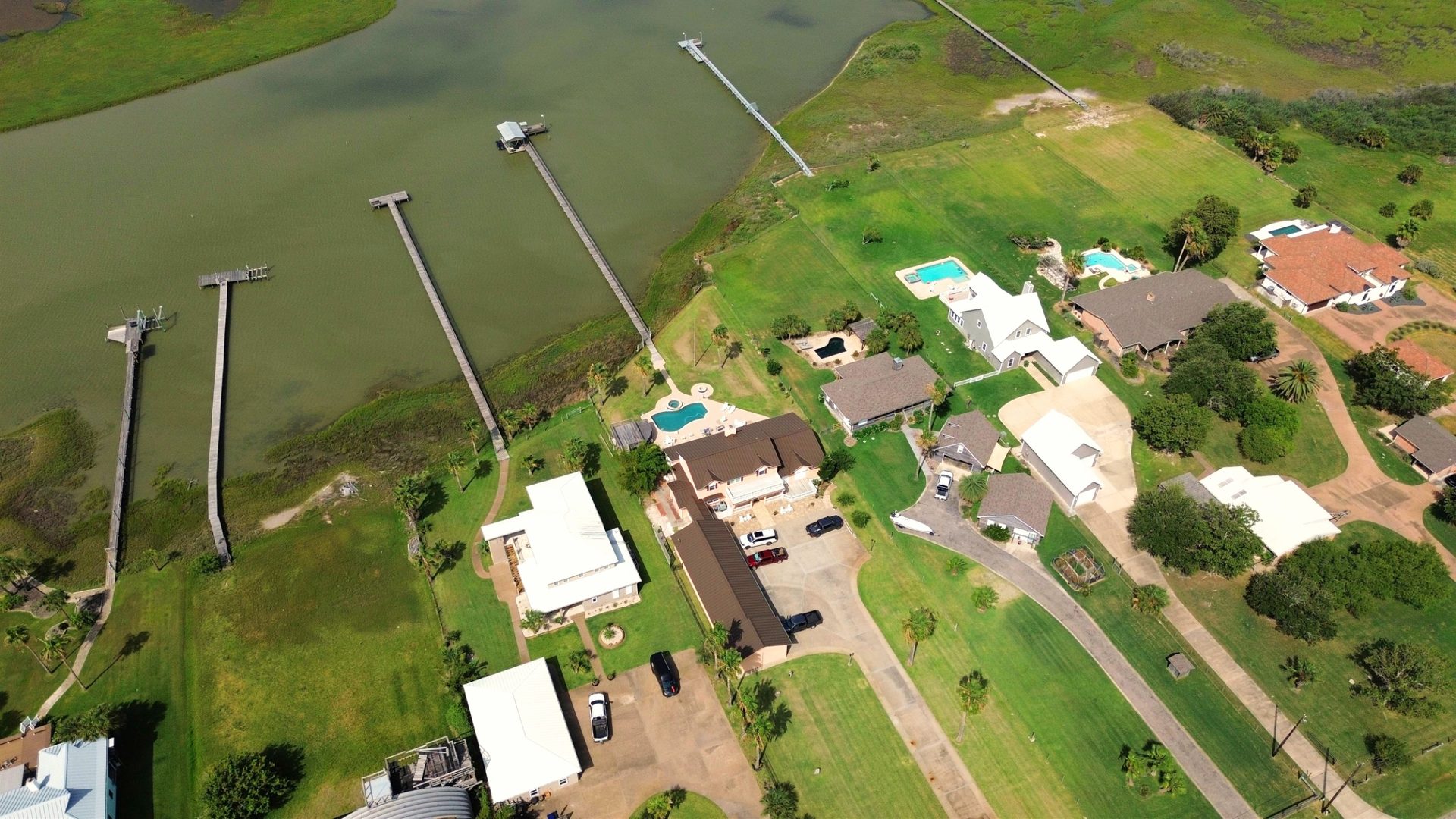 Aerial of waterfront properties with private fishing piers